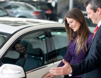 Car dealer showing car to customer